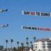 Remember ‘Say No To Suno’? Someone just hired a plane to fly it over an AI investor summit… featuring Mikey Shulman.